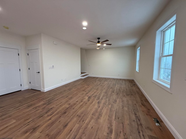 unfurnished room with dark hardwood / wood-style floors and ceiling fan