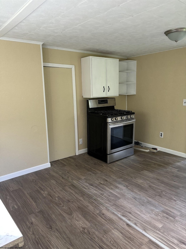 kitchen featuring white cabinets, crown molding, dark wood-type flooring, and gas range