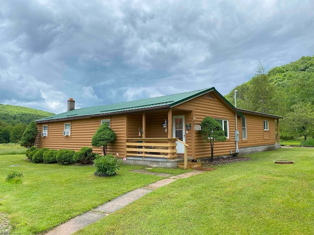 log-style house with a front lawn and a porch