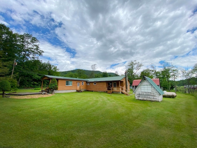 view of yard featuring a shed and a deck