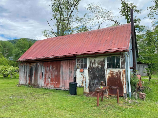 view of outbuilding with a lawn