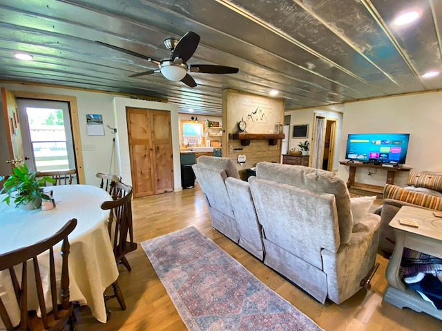 living room featuring wood-type flooring and ceiling fan