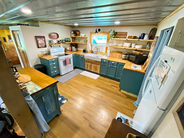 kitchen featuring white appliances, light hardwood / wood-style flooring, and sink