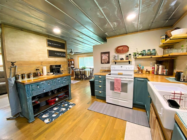 kitchen with white range with electric stovetop, butcher block counters, ceiling fan, and light hardwood / wood-style flooring