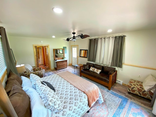 bedroom featuring ceiling fan, wood-type flooring, and baseboard heating