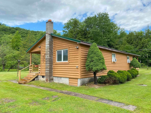 view of side of home with a lawn