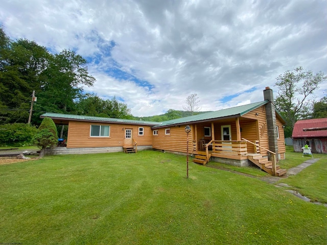 rear view of house with a lawn