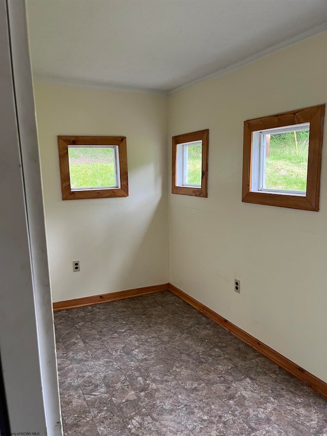 spare room with dark tile floors