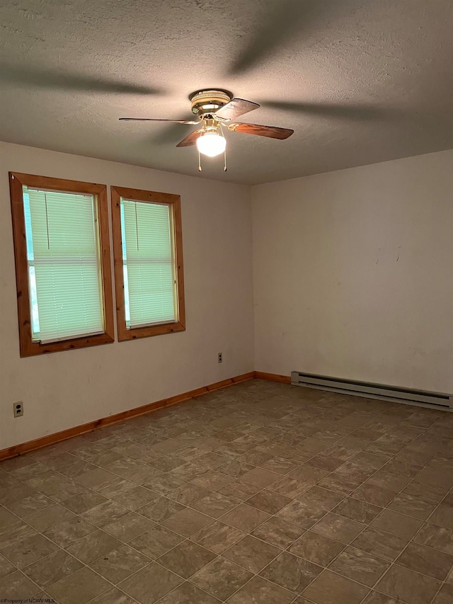 spare room featuring a baseboard heating unit, tile floors, a textured ceiling, and ceiling fan