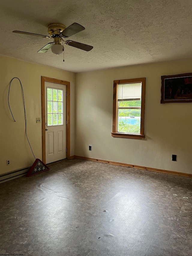 tiled spare room with ceiling fan and a textured ceiling