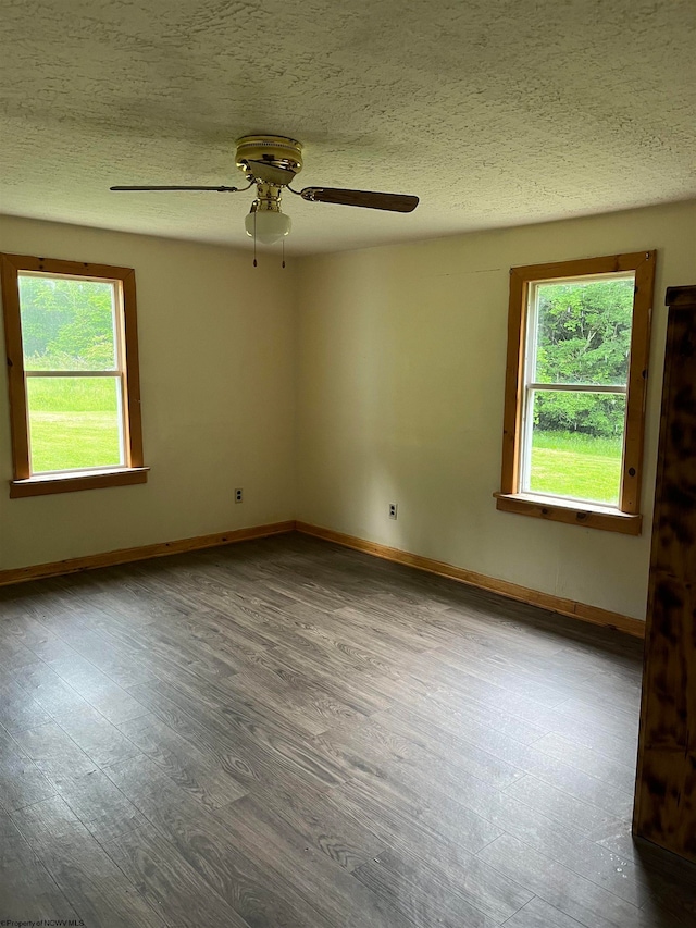 empty room with a textured ceiling, ceiling fan, and hardwood / wood-style floors