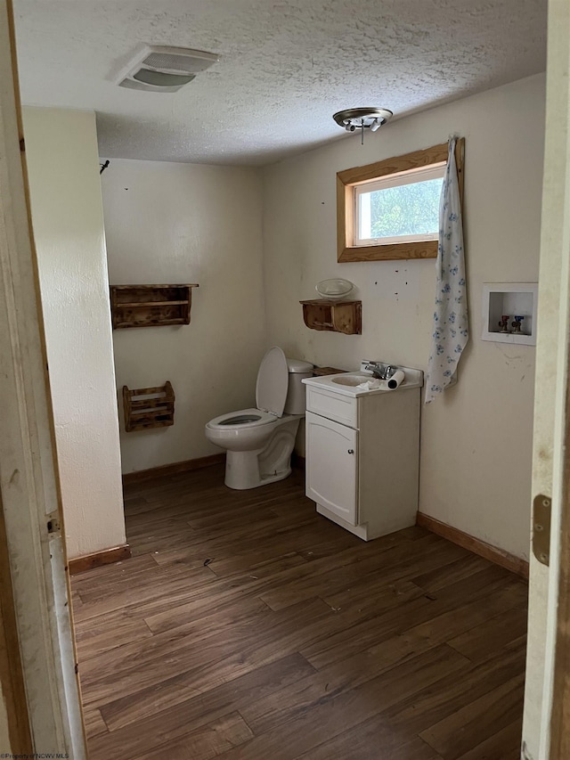 3485 Adolph Rd, Mill Creek, WV 26280 - bathroom featuring vanity, wood finished floors, toilet, a textured ceiling, and baseboards