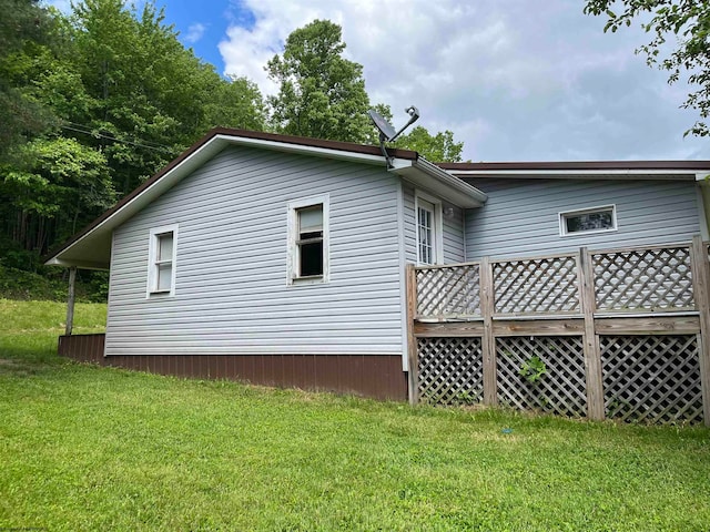 view of side of home featuring a yard