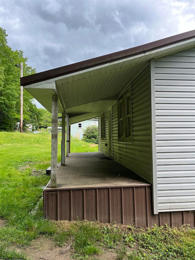 exterior space with a carport and a yard