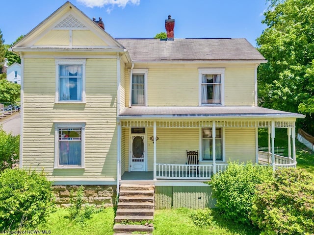 victorian-style house featuring a porch