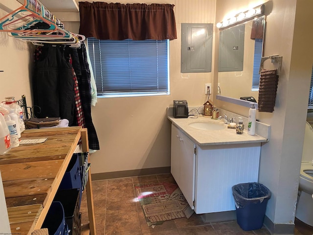 bathroom with vanity, toilet, electric panel, and tile patterned flooring