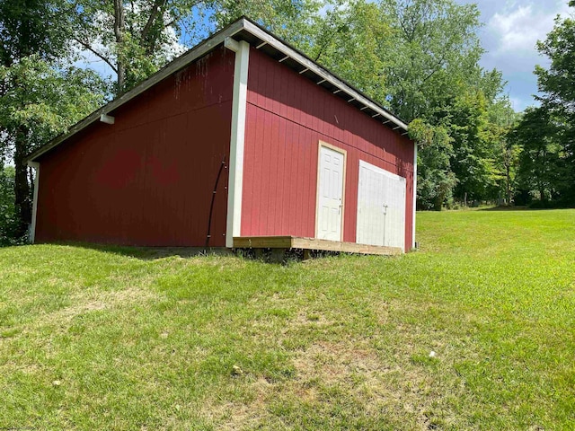 view of outbuilding featuring a lawn