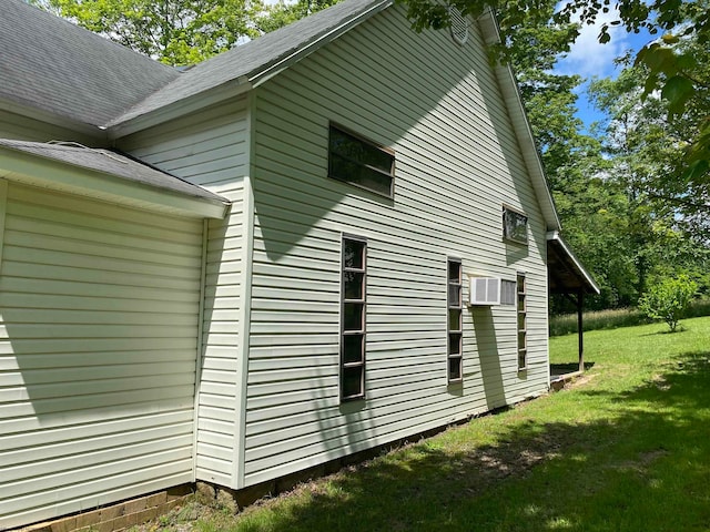 view of side of property with a lawn