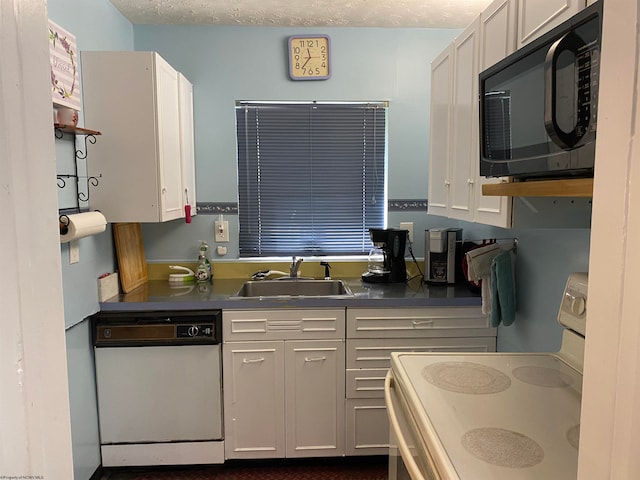 kitchen with stainless steel counters, sink, white dishwasher, stove, and white cabinets