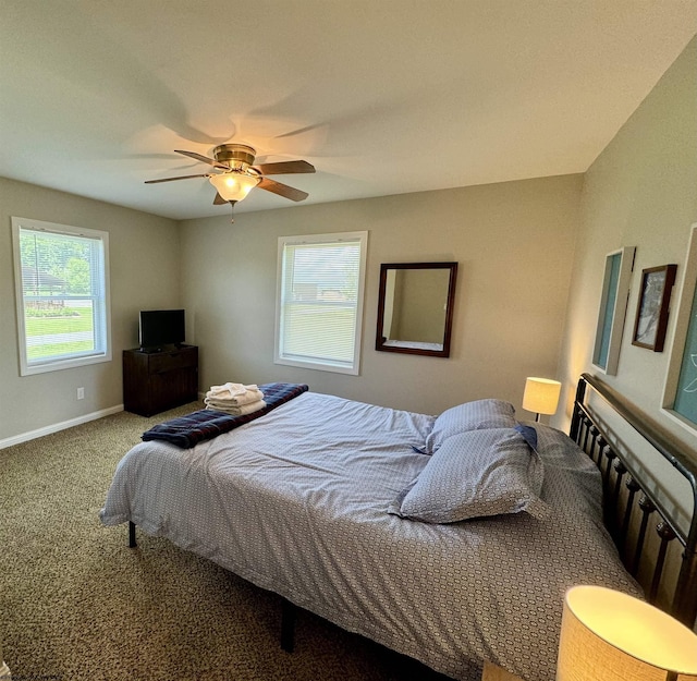 bedroom with carpet, ceiling fan, and multiple windows