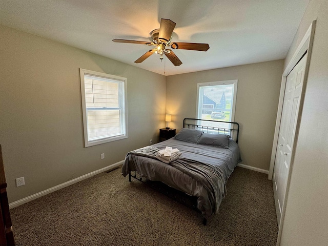 bedroom featuring a closet, dark carpet, and ceiling fan