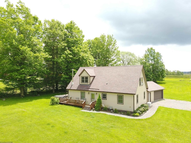 rear view of house with a lawn and a wooden deck