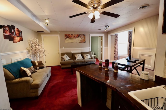 living room with dark carpet and ceiling fan