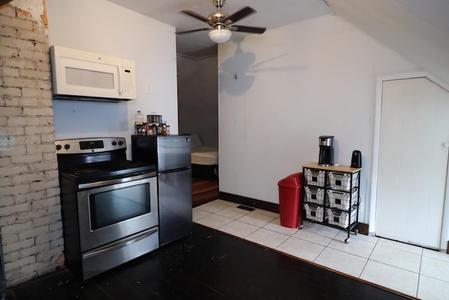 kitchen with refrigerator, ceiling fan, light tile patterned floors, and stainless steel electric range