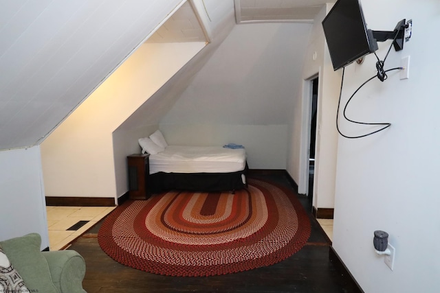 bedroom featuring tile patterned flooring and lofted ceiling