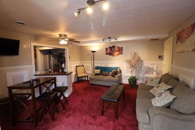 living room featuring carpet, track lighting, and ceiling fan