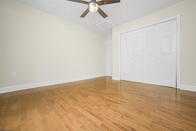 unfurnished bedroom featuring a closet, hardwood / wood-style flooring, and ceiling fan