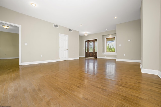 unfurnished living room featuring hardwood / wood-style floors