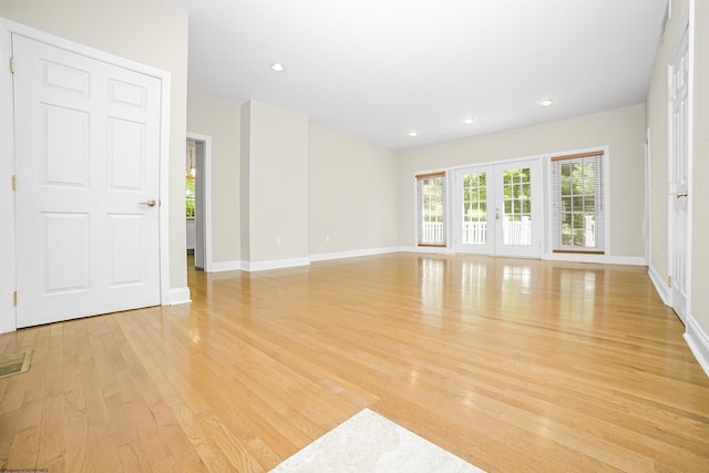 empty room featuring light hardwood / wood-style flooring and french doors