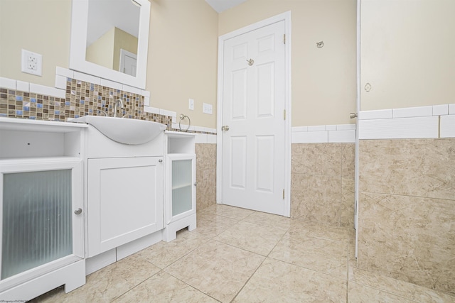 bathroom with tile patterned floors, vanity, and tile walls