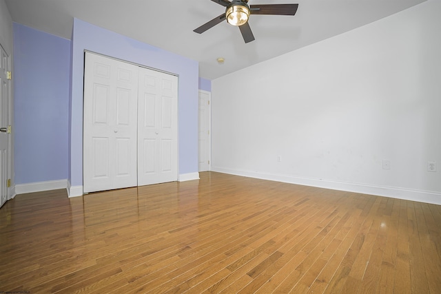 unfurnished bedroom featuring wood-type flooring, a closet, and ceiling fan