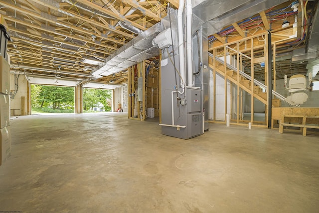 basement with electric panel and heating unit