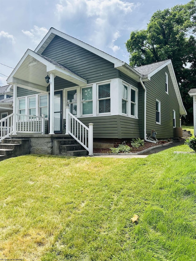 view of front facade with a front lawn and a porch