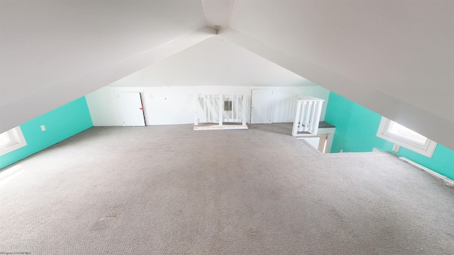 additional living space with carpet and vaulted ceiling