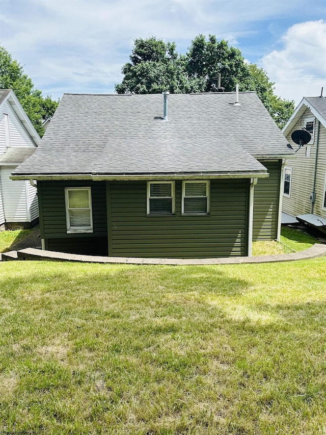 rear view of house featuring a yard