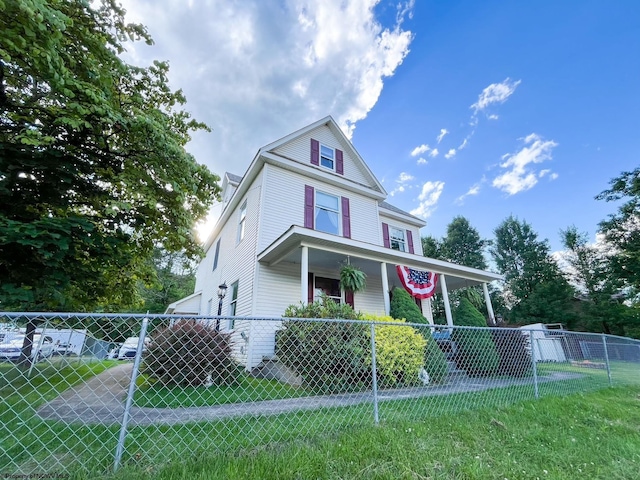 view of front facade with a front lawn and a porch