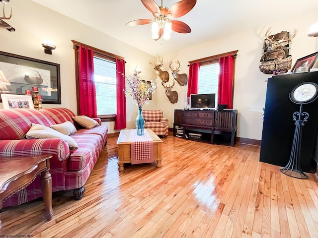 living room featuring light hardwood / wood-style floors and ceiling fan