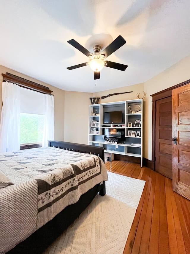 bedroom featuring wood-type flooring and ceiling fan