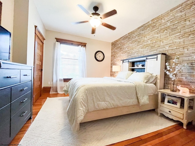 bedroom with ceiling fan and wood-type flooring