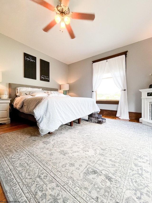 bedroom with ceiling fan and hardwood / wood-style floors