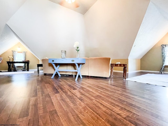 interior space featuring hardwood / wood-style flooring and vaulted ceiling