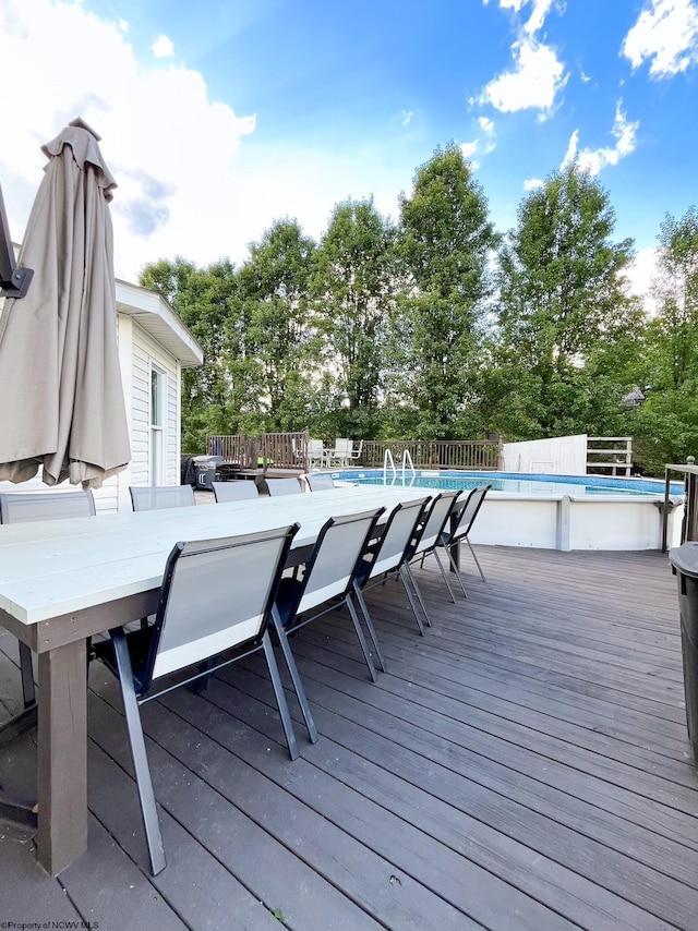 deck featuring a fenced in pool