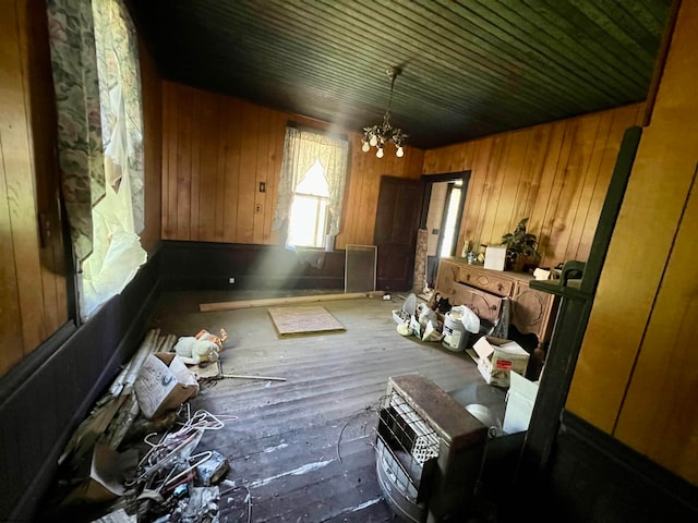 miscellaneous room featuring a chandelier, hardwood / wood-style flooring, wooden ceiling, and wood walls