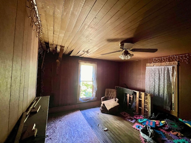 bedroom with wooden walls, hardwood / wood-style flooring, and wooden ceiling