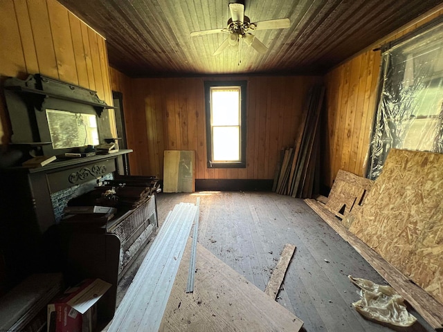 miscellaneous room with ceiling fan, wood walls, and wooden ceiling