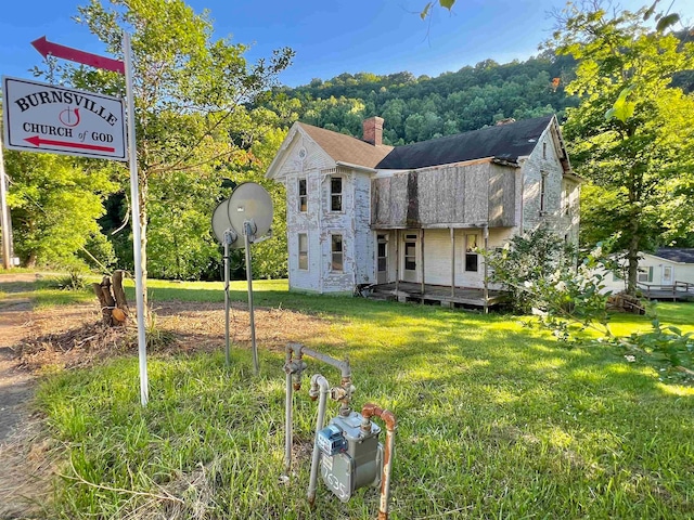 back of house with a yard